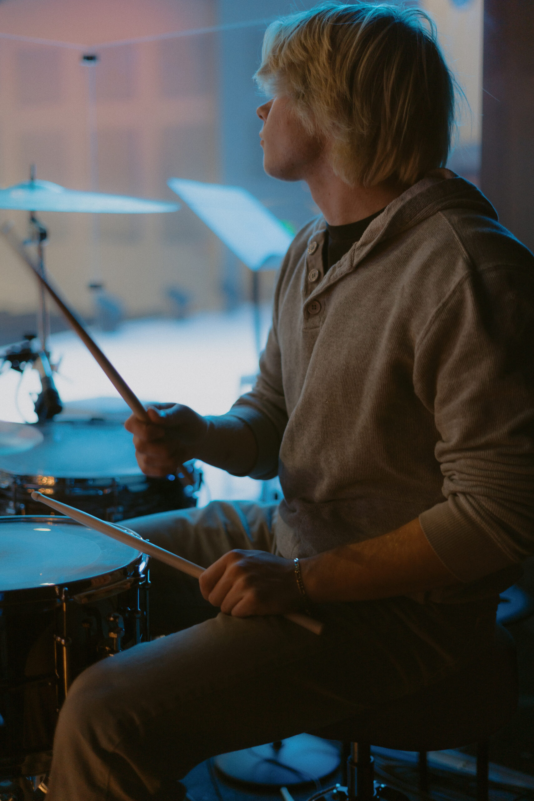 A high school senior boy playing drums