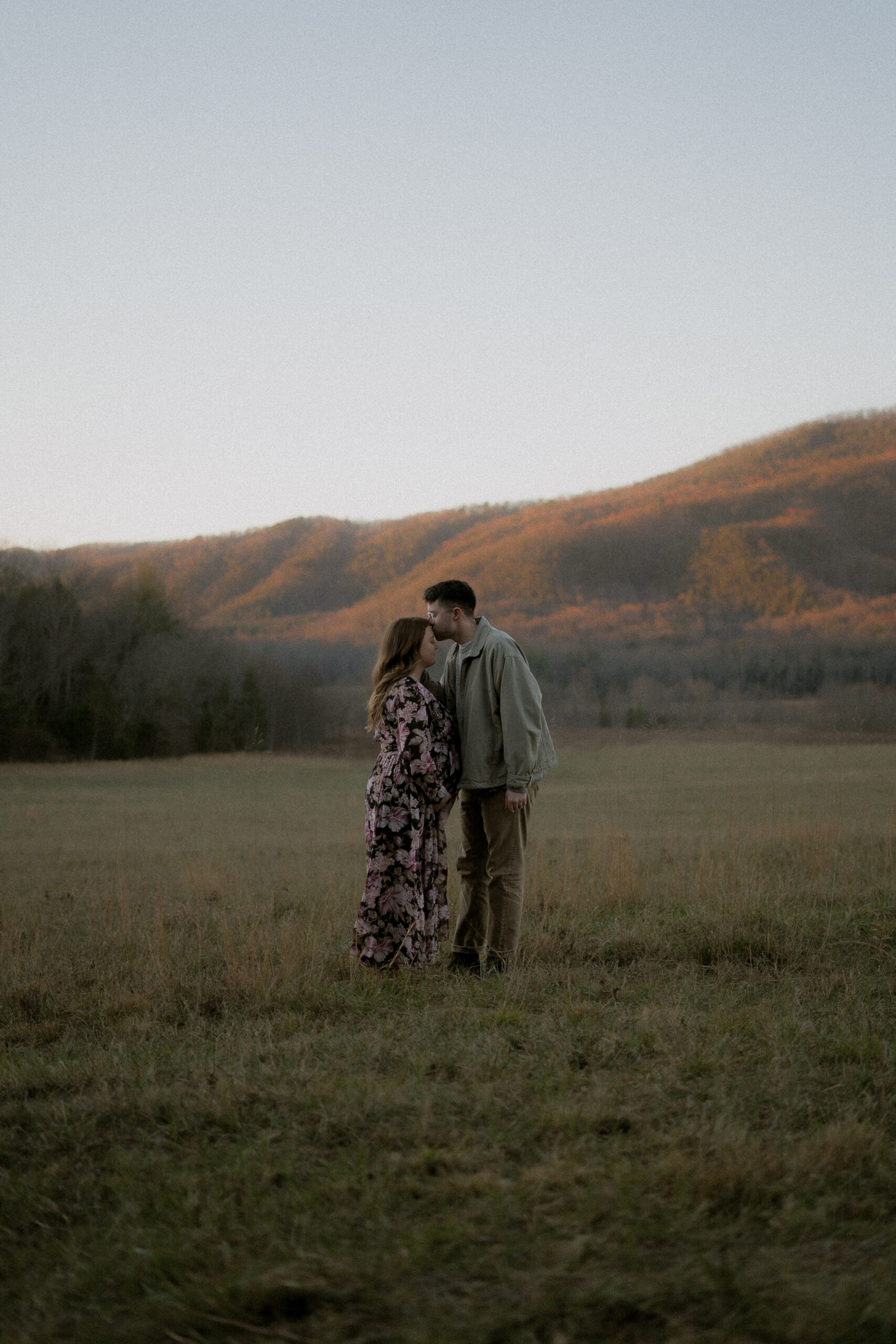 Couple at a maternity session kissing in the Smoky Mountains